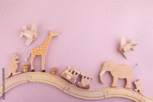 Zero waste. Eco wooden toys on pink background. Flat lay. Top view