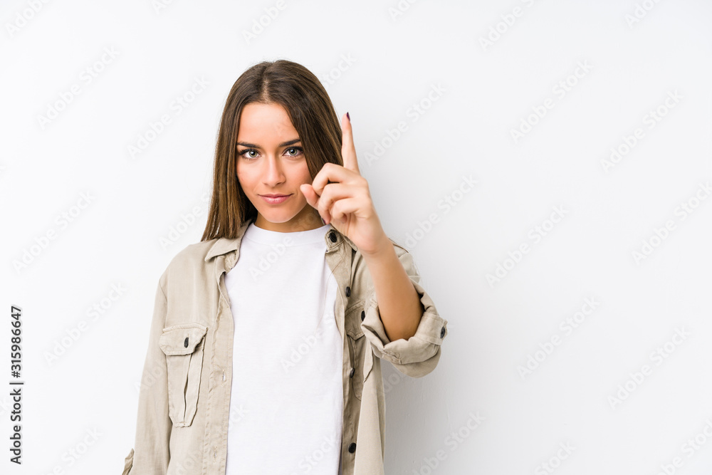 Young caucasian woman isolated showing number one with finger. Young caucasian woman isolated showing number one with finger.
