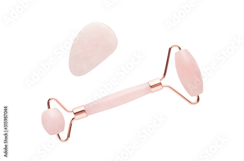 rose quartz facial roller and massage stone gua sha isolated on white background, flat lay