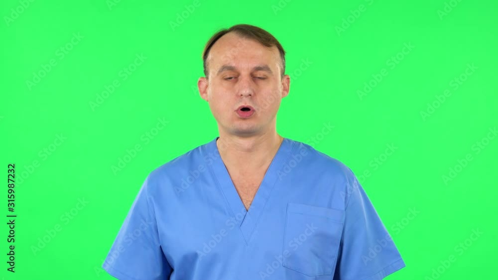 Medical man is upset and tired, sighs. Green screen Medical man is upset and tired, sighs. Green screen