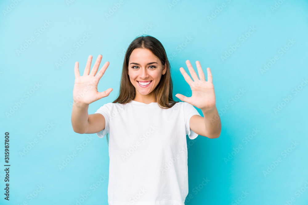 Young caucasian woman  isolated showing number ten with hands.