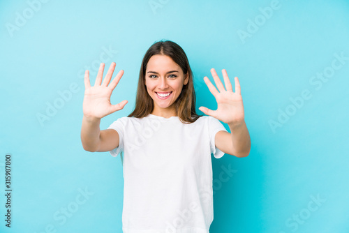 Young caucasian woman  isolated showing number ten with hands.