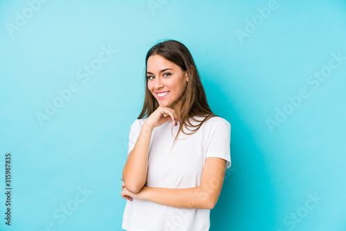 Young caucasian woman isolated smiling happy and confident, touching chin with hand.