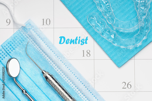 Orthodontist or Dentist appointment in calendar professional dental tools with invisalign braces.
