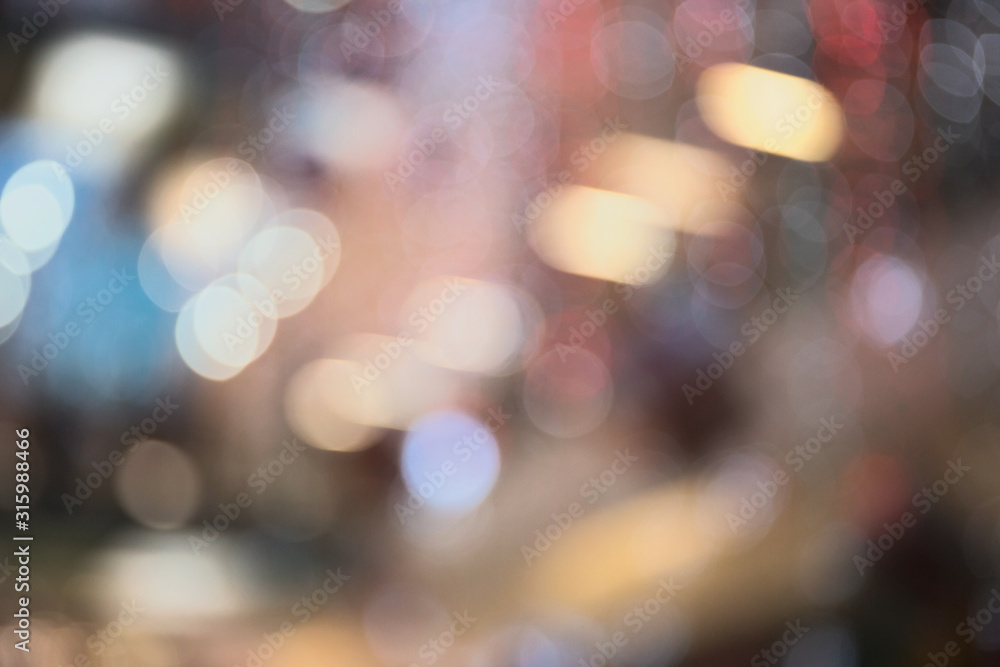 Abstract blurred and defocused background of shopping mall with bokeh. Christmas lights and garlands.