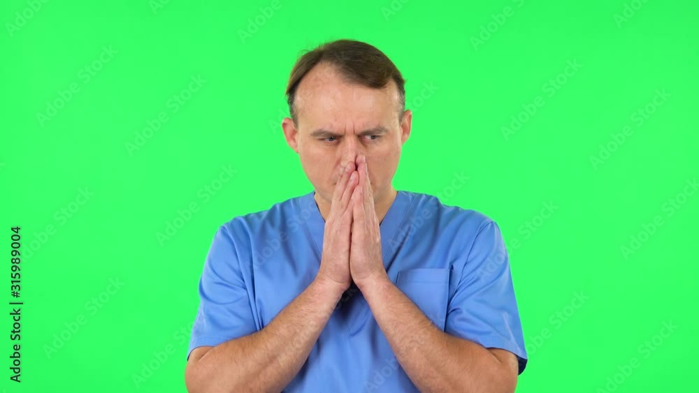 Medical man thinks about something, and then an idea comes to him. Green screen Medical man thinks about something, and then an idea comes to him. Green screen