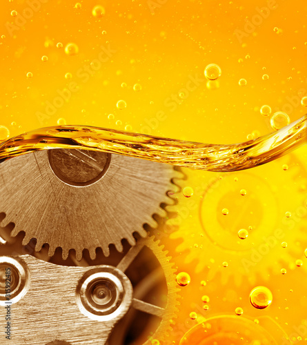 Metal gear in oil. Car service concept. Oil change in mechanisms, engines, motors.