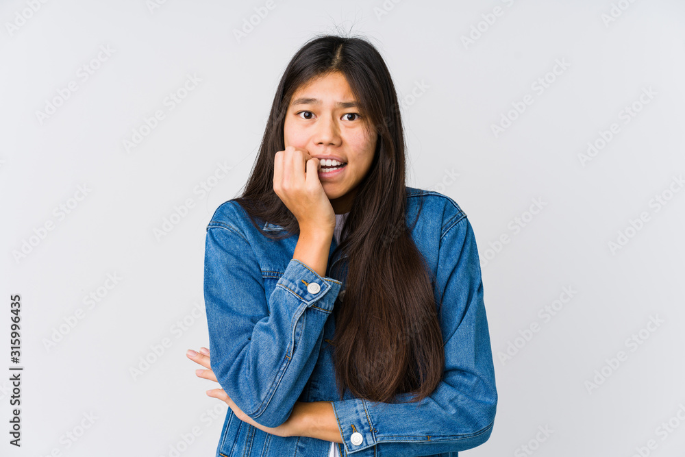 Young asian woman biting fingernails, nervous and very anxious. Young asian woman biting fingernails, nervous and very anxious.