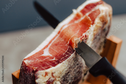 Slicing slices of a spanish iberian serrano ham