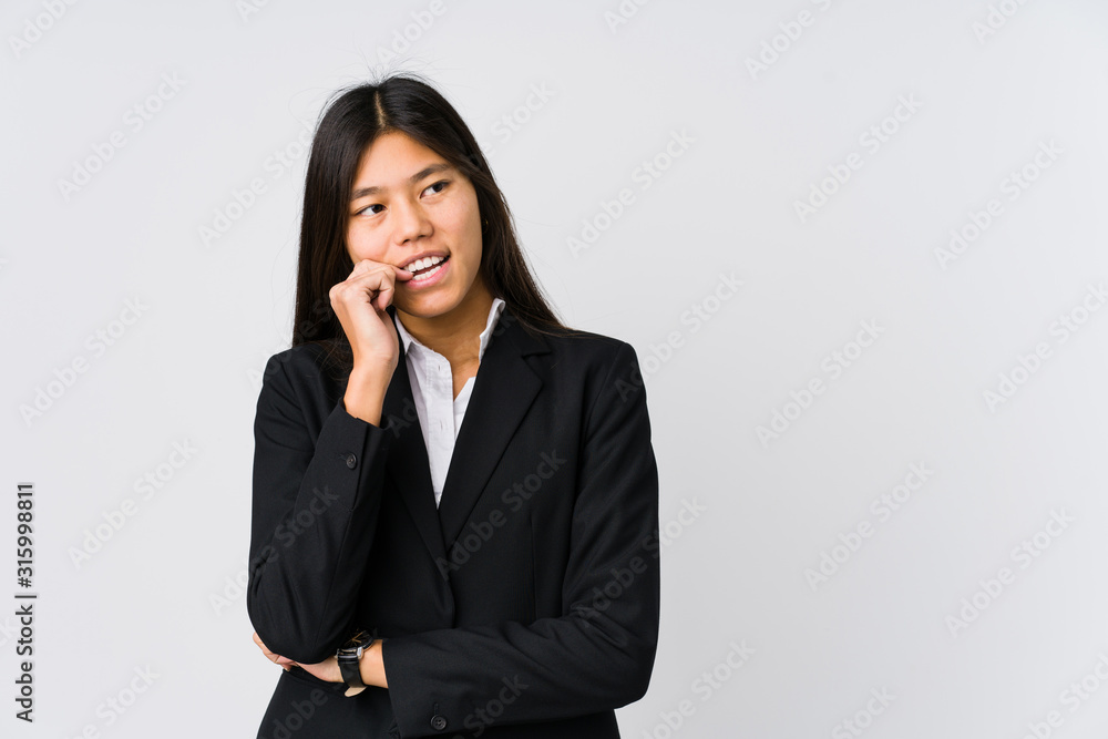 Young asian business woman relaxed thinking about something looking at a copy space. Young asian business woman relaxed thinking about something looking at a copy space.