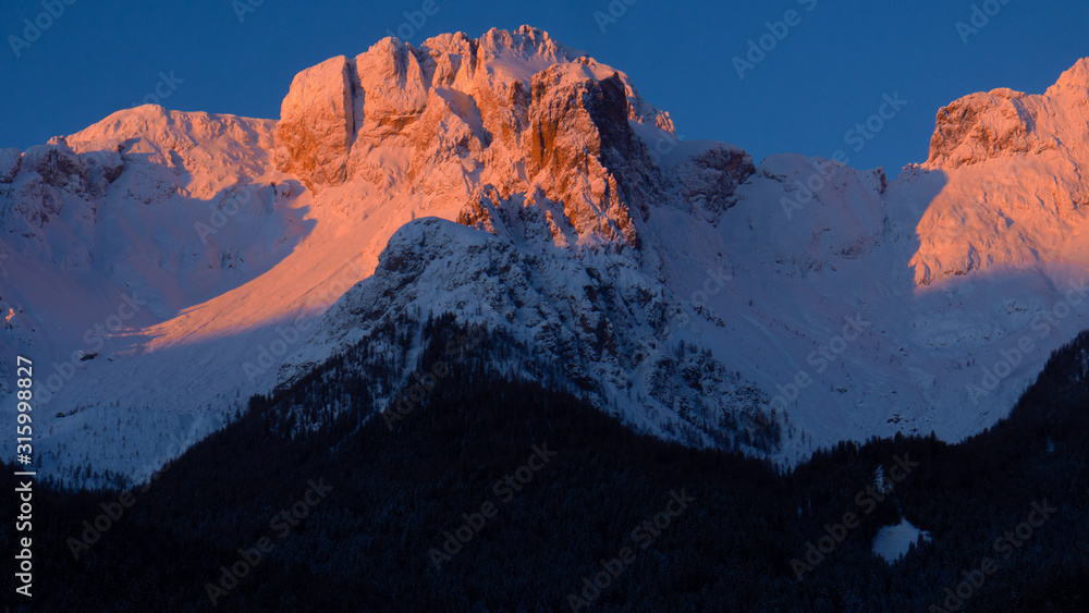snow covered mountains during colourful sunset in the dolomiti
