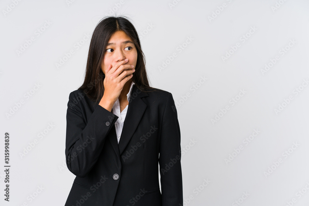 Young asian business woman thoughtful looking to a copy space covering mouth with hand. Young asian business woman thoughtful looking to a copy space covering mouth with hand.