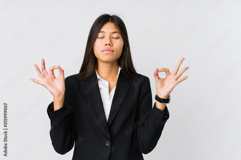 Young asian business woman relaxes after hard working day, she is performing yoga. Young asian business woman relaxes after hard working day, she is performing yoga.