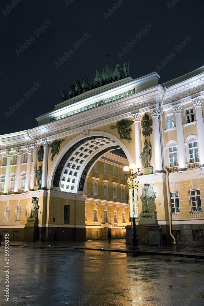 Triumphal arch of the General staff building in Saint Petersburg, Russia. Ancient architecture of Saint Petersburg. Reflection in the water. Rainy day.