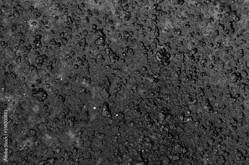 Black dented granite texture background