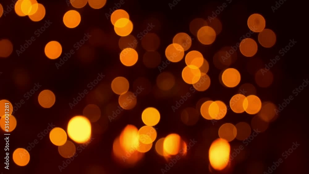 Christmas atmosphere, golden bokeh and garland lights at night, new year decorations twinkling fast, lighting up and fading out by yellow and orange colors, abstract holiday background Christmas atmosphere, golden bokeh and garland lights at night, new year decorations twinkling fast, lighting up and fading out by yellow and orange colors, abstract holiday background