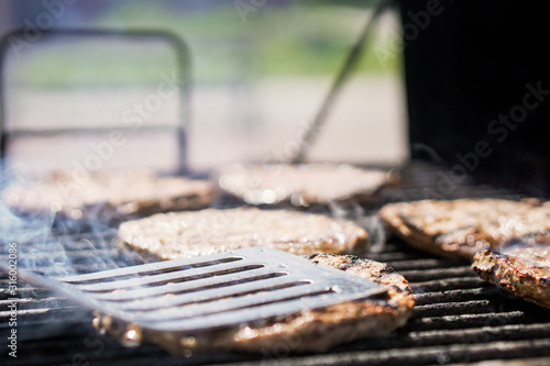 Burgers on the grill with smoke
