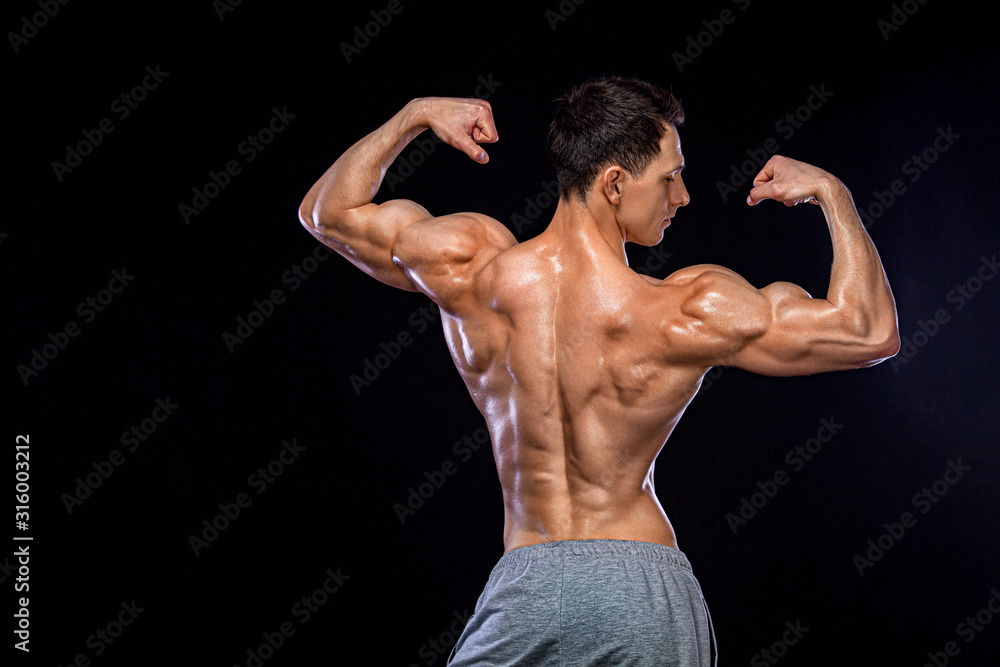 Athlete bodybuilder. Strong and fit man. Sporty muscular guy on black background. Sport and fitness motivation. Individual sports recreation. Athlete bodybuilder. Strong and fit man. Sporty muscular guy on black background. Sport and fitness motivation. Individual sports recreation.