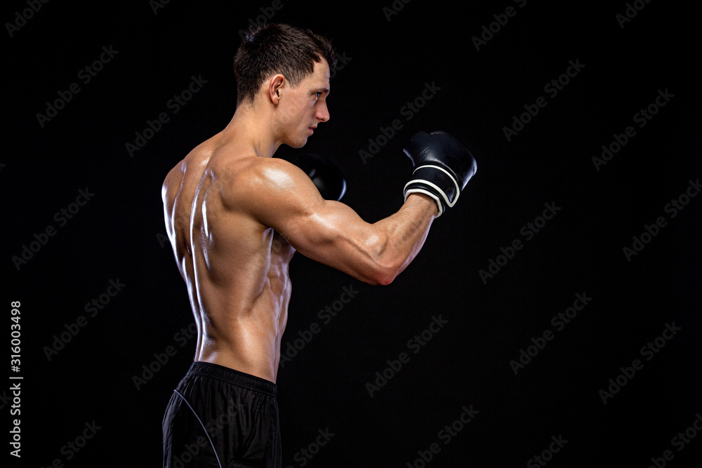 Fitness and boxing concept. Boxer, man fighting or posing in gloves on black background. Individual sports recreation.