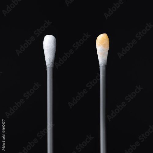 Before and after using the ear stick. Cotton sticks isolated on black background