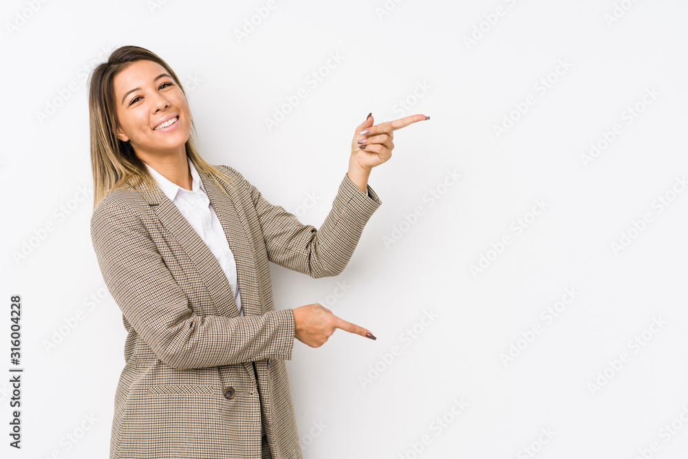 Young caucasian business woman isolated excited pointing with forefingers away.