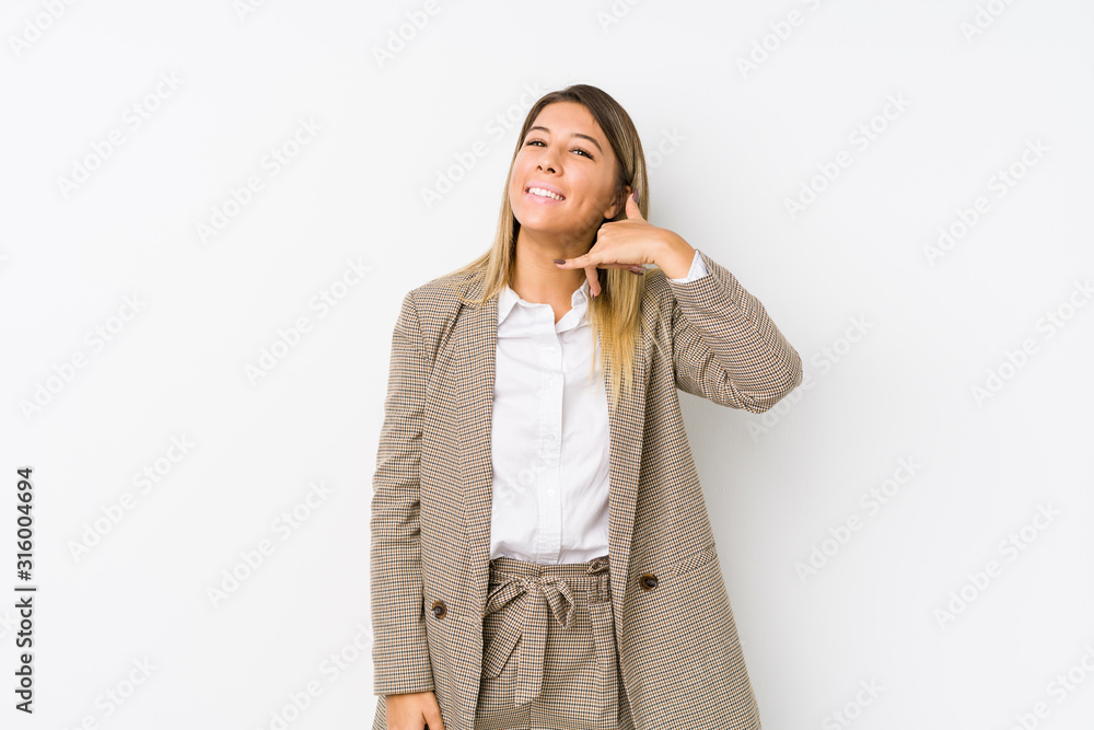 Young caucasian business woman isolated showing a mobile phone call gesture with fingers. Young caucasian business woman isolated showing a mobile phone call gesture with fingers.