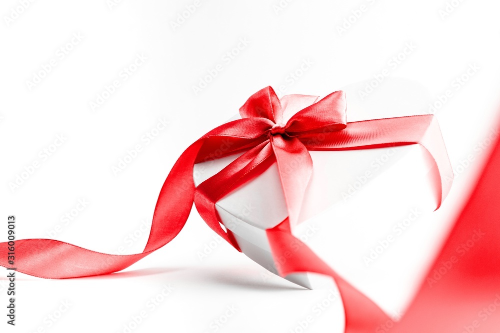 Valentines day gift box with red ribbon isolated on white background. Concept of Valentines, anniversary, mothers day and birthday greeting, copyspace, topview. Valentines day gift box with red ribbon isolated on white background. Concept of Valentines, anniversary, mothers day and birthday greeting, copyspace, topview.
