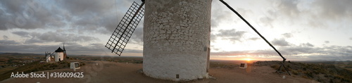 A traditional Spanish windmill in the top of a hill in the town of Consuegra, which is located in the province of Toledo, in Spain, Europe.