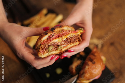 Burger slice in girls hands