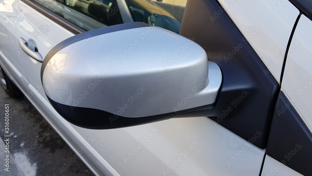 Closeup of a side view car mirror. Passenger side Silver car