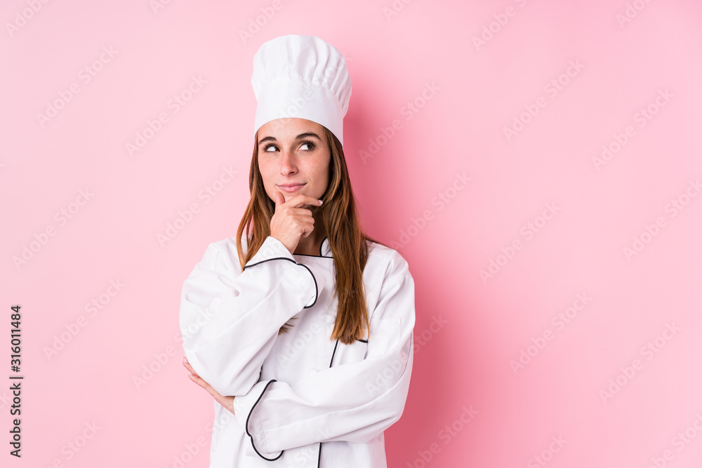 Young caucasian chef woman isolated looking sideways with doubtful and skeptical expression. Young caucasian chef woman isolated looking sideways with doubtful and skeptical expression.