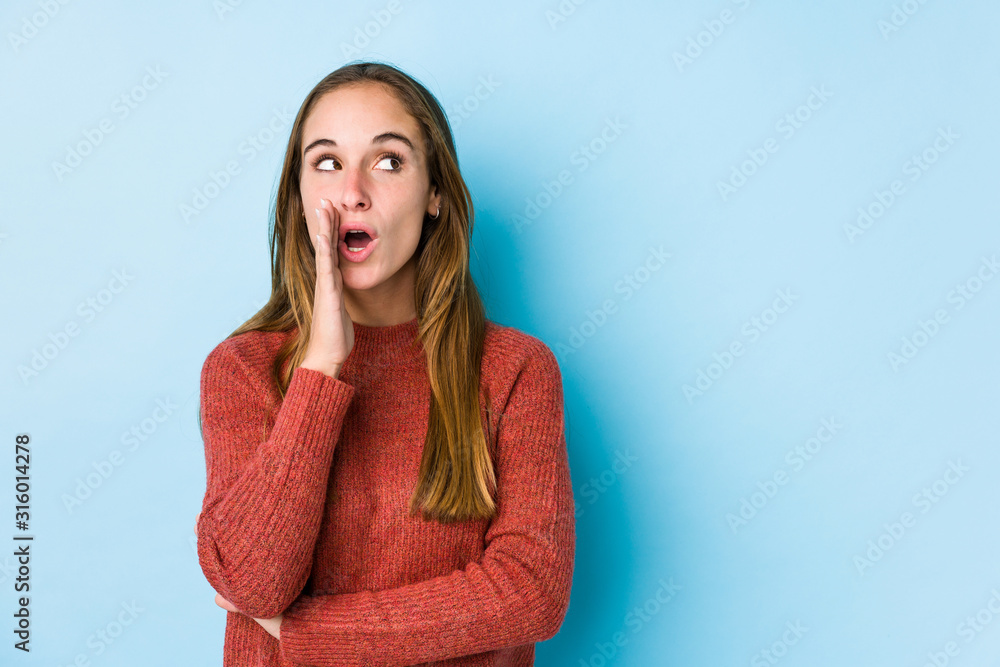 Young caucasian woman posing isolated is saying a secret hot braking news and looking aside Young caucasian woman posing isolated is saying a secret hot braking news and looking aside