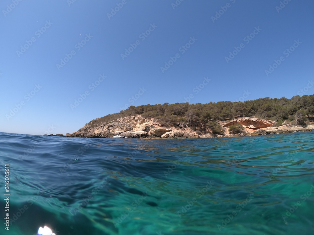 View of the a beach of mallorca with sea colour turquoise and blue sky concept of holiday and summer