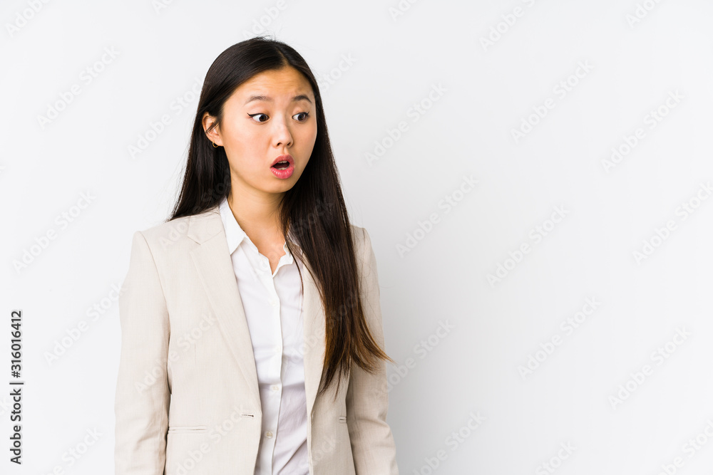 Young business chinese woman isolated being shocked because of something she has seen. Young business chinese woman isolated being shocked because of something she has seen.