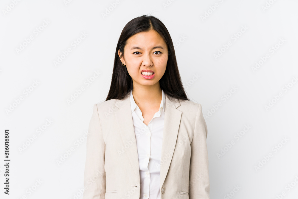 Young chinese business woman isolated screaming very angry and aggressive. Young chinese business woman isolated screaming very angry and aggressive.