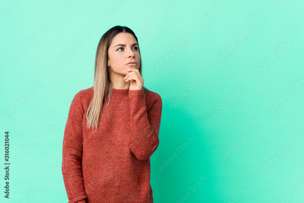 Young caucasian woman isolated looking sideways with doubtful and skeptical expression. Young caucasian woman isolated looking sideways with doubtful and skeptical expression.