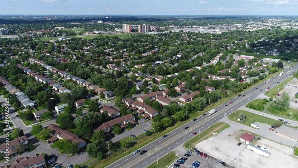 Flying Over Four Lanes Of Traffic Towards Residential Area Flying Over Four Lanes Of Traffic Towards Residential Area