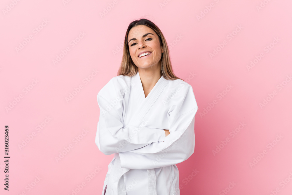 Young karate woman laughing and having fun. Young karate woman laughing and having fun.