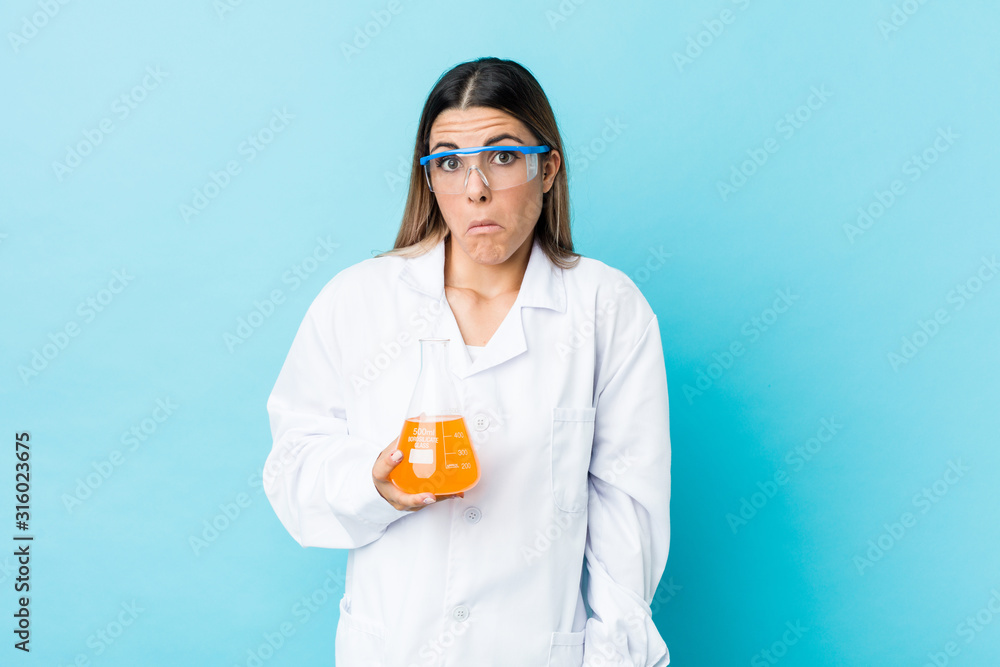 Young scientific woman shrugs shoulders and open eyes confused. Young scientific woman shrugs shoulders and open eyes confused.