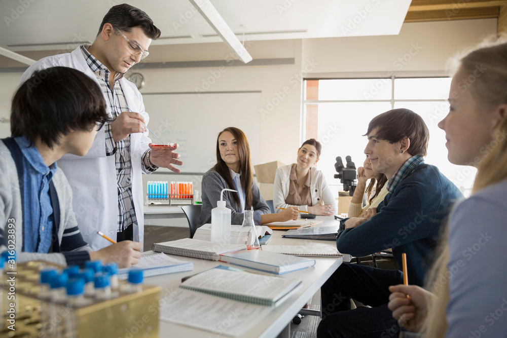 High school students and teacher conducting scientific experiment Stock ...