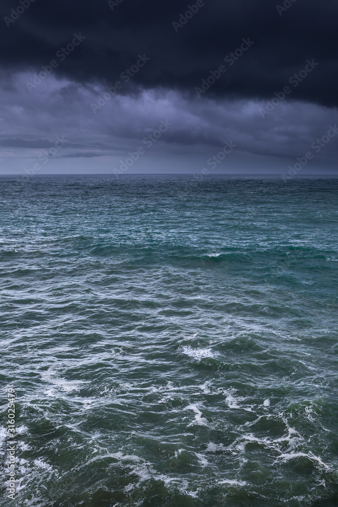 The ocean surface at the cloudy stormy day. Breathtaking romantic seascape.