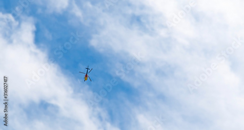Let's go :  Blur Image in motion Helicopter flying in the blue sky