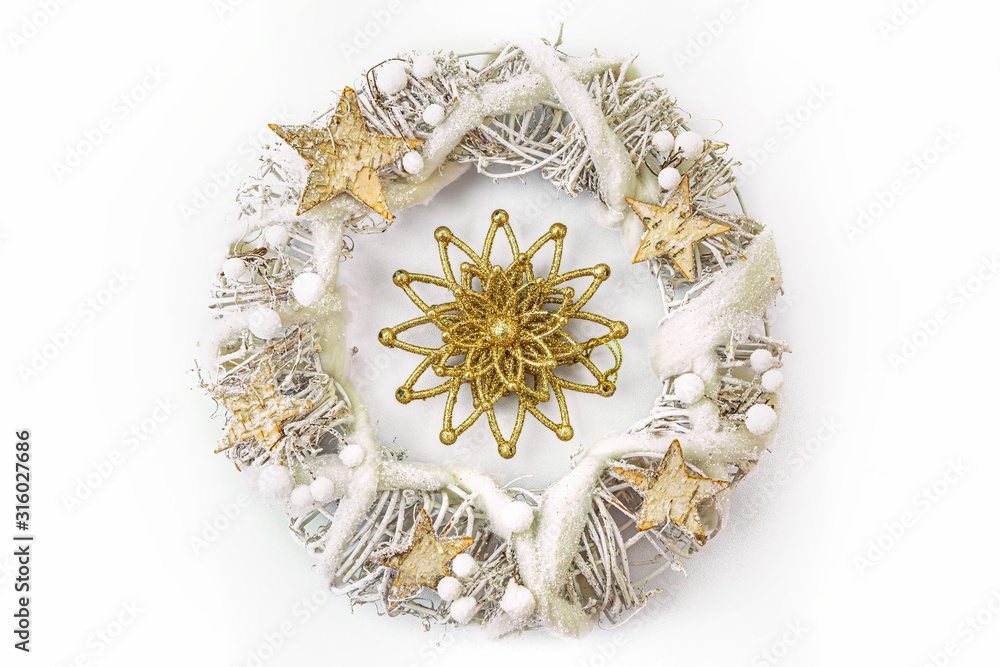 Christmas wreath made from dried twigs, decorated with stars and other decorations.