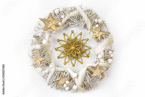 Obraz na płótnie Christmas wreath made from dried twigs, decorated with stars and other decorations. w salonie