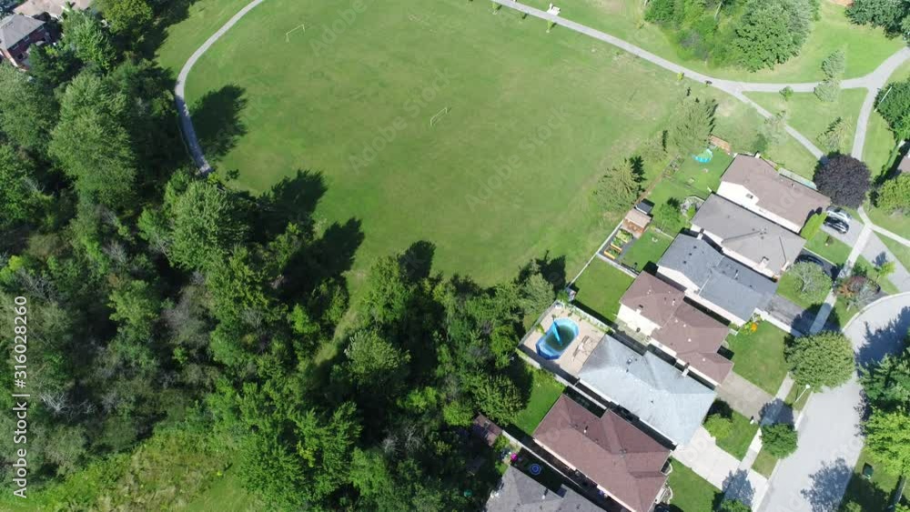 Aerial Over Rooftops To Large Open Park With Soccer Field Aerial Over Rooftops To Large Open Park With Soccer Field