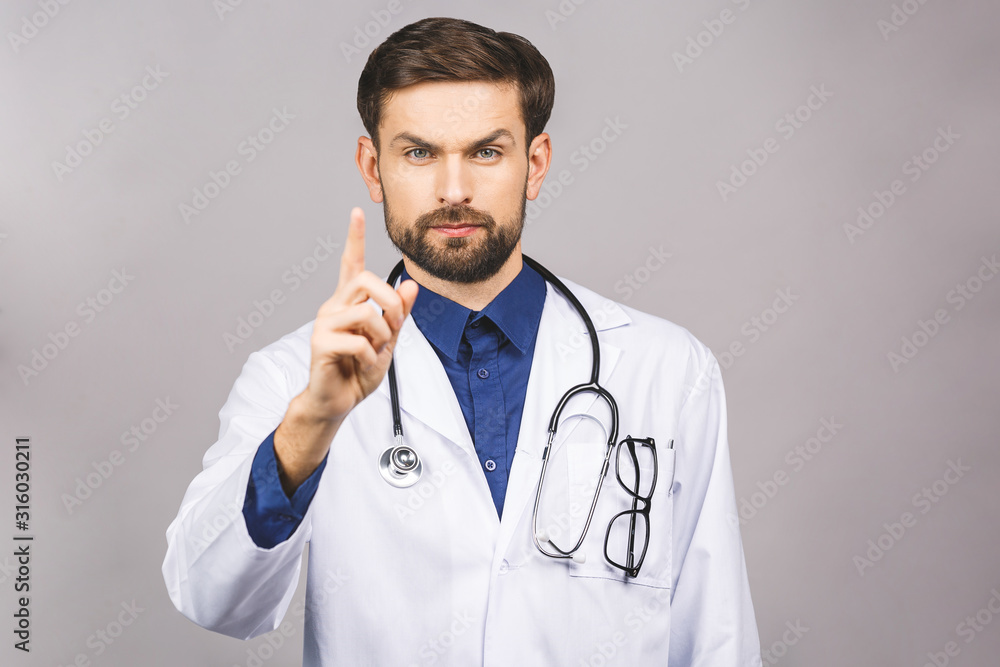 Angry male doctor pointing finger at you with stethoscope around his neck, pointing at camera with serious face isolated on grey background. Angry male doctor pointing finger at you with stethoscope around his neck, pointing at camera with serious face isolated on grey background.