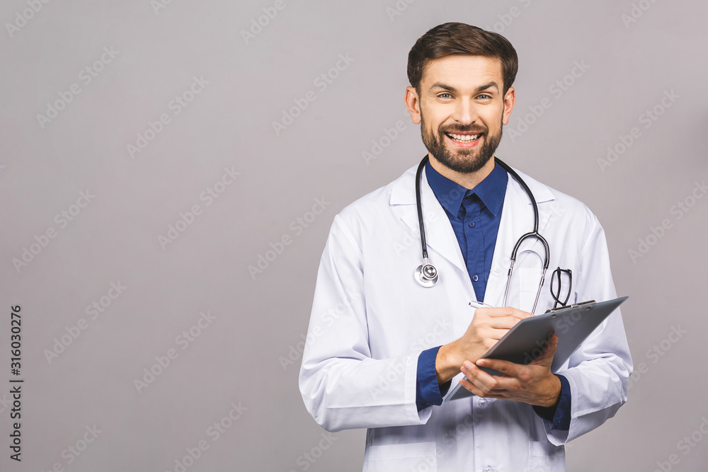 Happy smiling doctor writing recipe on clipboard, isolated on grey background. Happy smiling doctor writing recipe on clipboard, isolated on grey background.