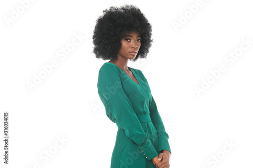 Elegant afro-americna model in bootle green dress looks very glamour.