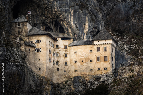 Predjama Castle built within a cave mouth in Slovenia photo