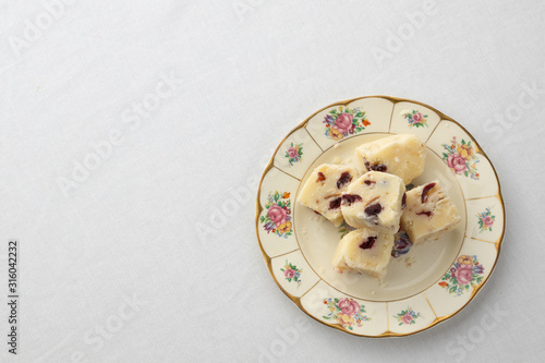 White fudge on pretty floral plate with white background